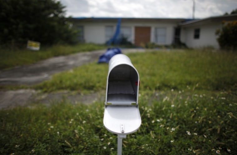 Image: An empty mail box is seen at the front door of a foreclosed house in Miami Gardens